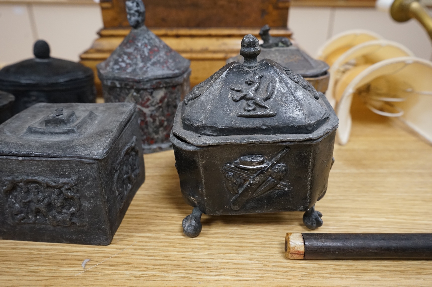 A collection of eleven early 19th century lead tobacco boxes to include an octagonal example with remains of red paint, largest 13cm wide